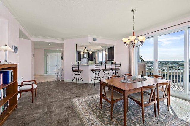 dining area with crown molding, a notable chandelier, and baseboards