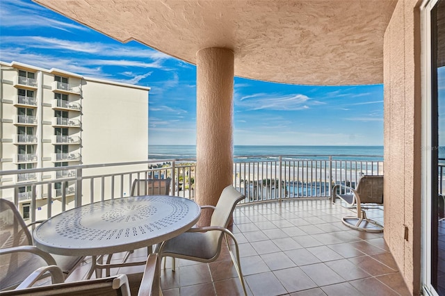 balcony with a beach view and a water view