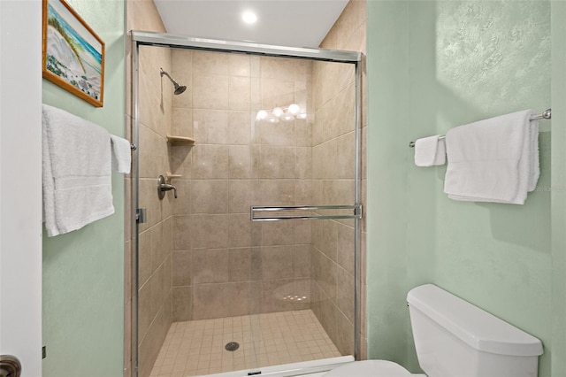 full bathroom with a stall shower and toilet