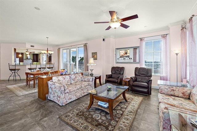 living room featuring baseboards, visible vents, ornamental molding, and ceiling fan with notable chandelier