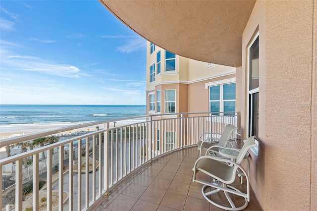 balcony with a view of the beach and a water view