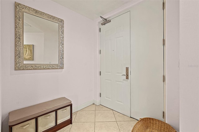 interior space with baseboards and light tile patterned floors