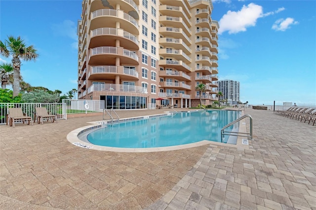 pool featuring a patio and fence