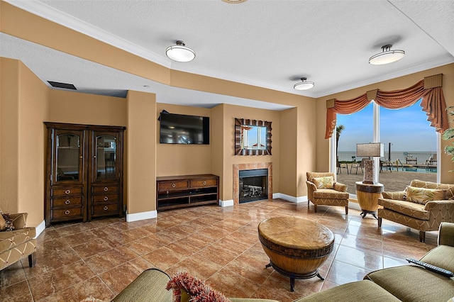 living area with a textured ceiling, a tiled fireplace, and baseboards