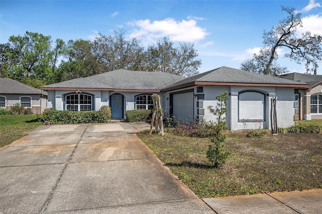 ranch-style house with an attached garage, driveway, and stucco siding