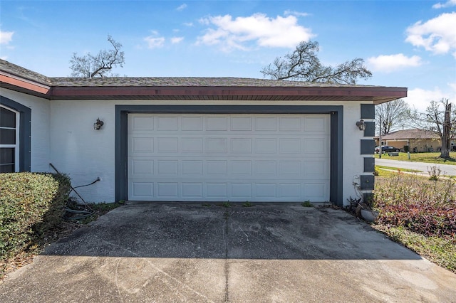 garage with concrete driveway