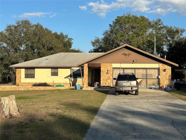 ranch-style house with stone siding, concrete driveway, and a front lawn