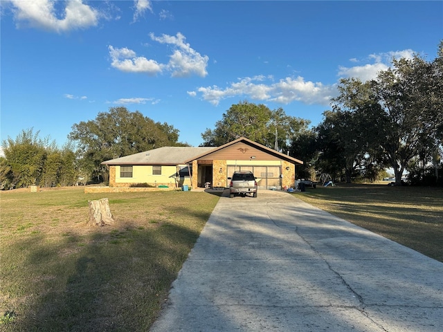 ranch-style house with a garage, a front yard, and concrete driveway