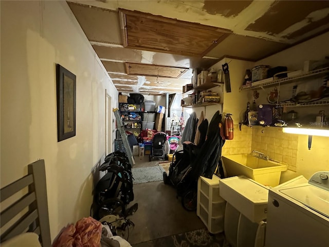 below grade area with washer / clothes dryer and a sink