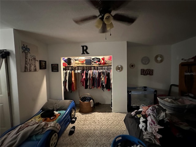 bedroom featuring ceiling fan and a closet