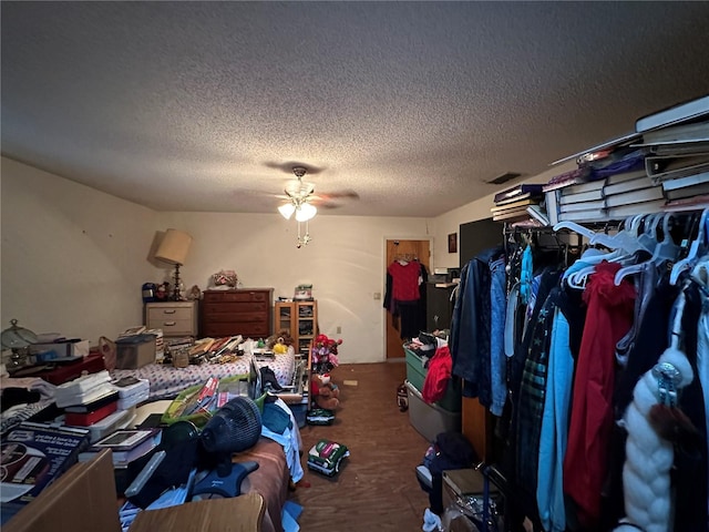 bedroom featuring a textured ceiling and a ceiling fan