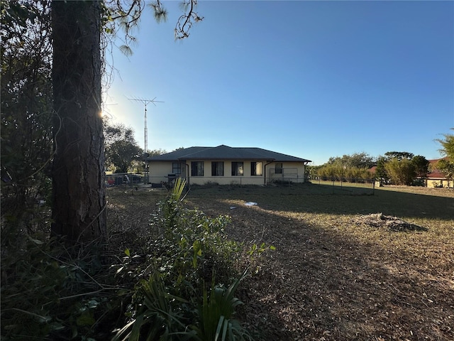 rear view of house featuring fence