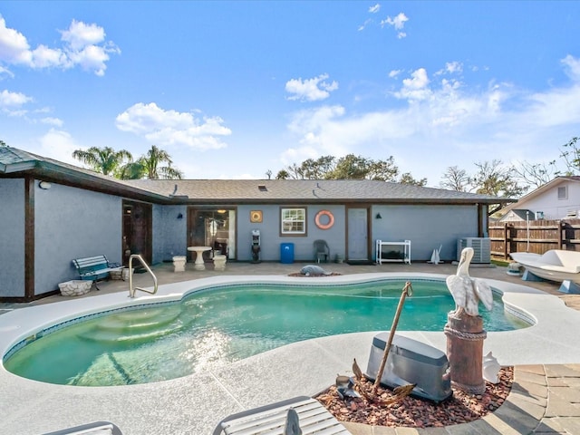 view of swimming pool featuring a fenced in pool, cooling unit, a patio, and fence