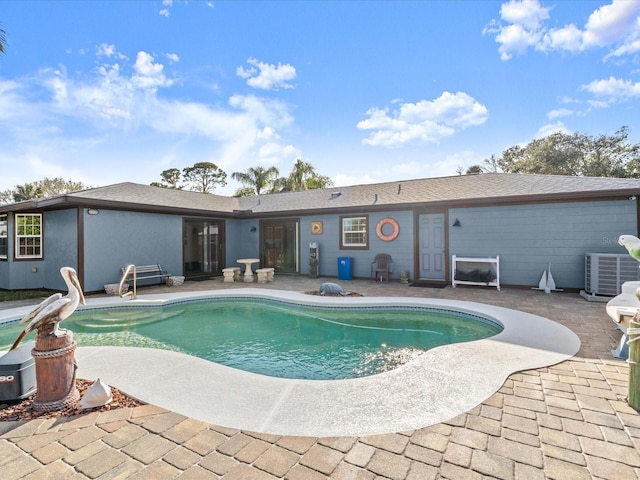 outdoor pool featuring a patio and central AC