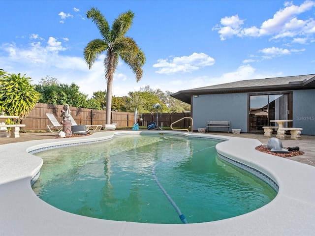 view of swimming pool with a patio, a fenced in pool, and a fenced backyard