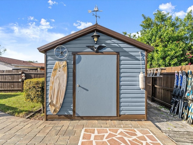 view of shed featuring fence