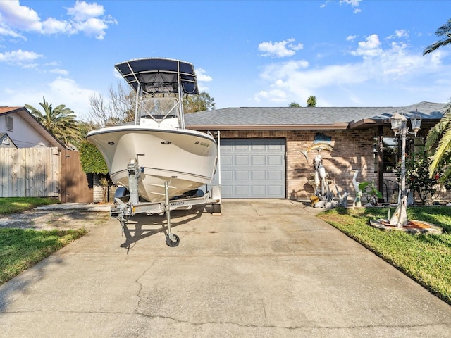 view of front of house with fence, roof with shingles, concrete driveway, an attached garage, and brick siding