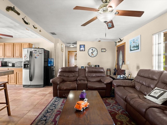 living area with a toaster, light tile patterned flooring, visible vents, and ceiling fan