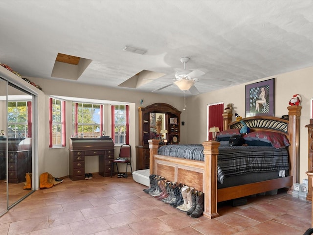 bedroom featuring visible vents, multiple windows, and ceiling fan