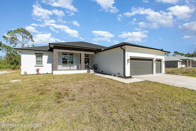 prairie-style home featuring covered porch, a front lawn, and an attached garage