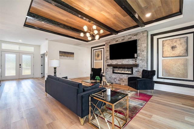 living area with baseboards, wood ceiling, wood finished floors, french doors, and beam ceiling