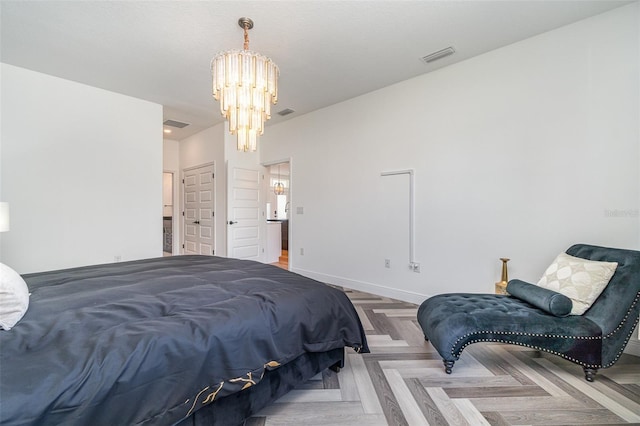 bedroom with visible vents, baseboards, and a notable chandelier