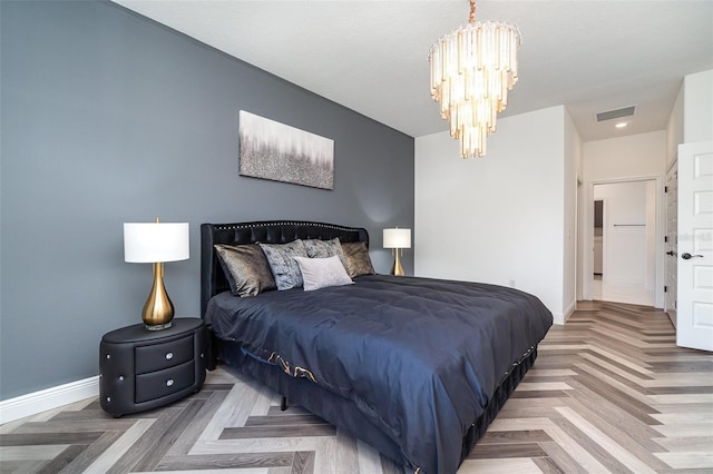 bedroom with a notable chandelier, visible vents, and baseboards