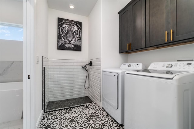 laundry area featuring cabinet space and separate washer and dryer