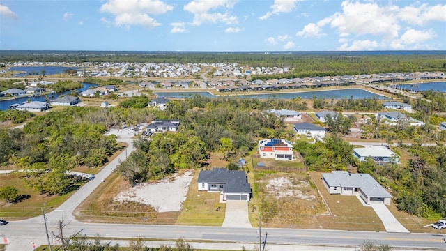 drone / aerial view with a water view and a residential view