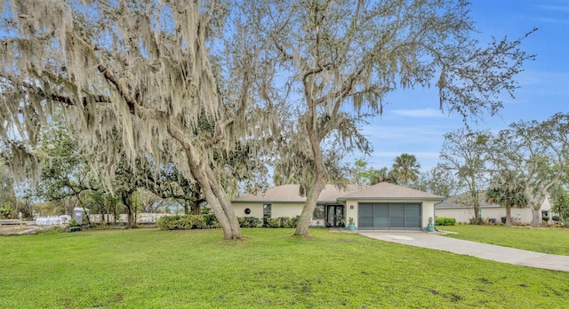 ranch-style house with a garage, driveway, a front lawn, and stucco siding