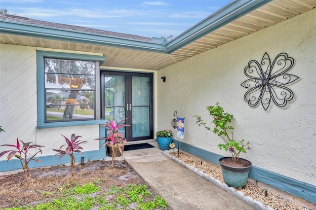 view of exterior entry with stucco siding