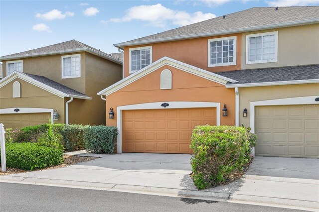 3691 Titanic Cir, Melbourne, FL 32903 - view of front of house with stucco siding, concrete driveway, and an attached garage