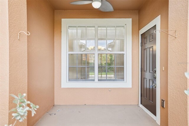 3691 Titanic Cir, Melbourne, FL 32903 - property entrance with stucco siding and ceiling fan