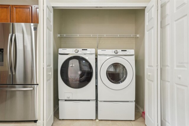 3691 Titanic Cir, Melbourne, FL 32903 - washroom with independent washer and dryer, light tile patterned floors, and baseboards