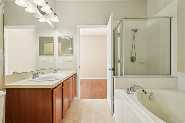 3691 Titanic Cir, Melbourne, FL 32903 - bathroom with a garden tub, double vanity, tile patterned floors, and tiled shower