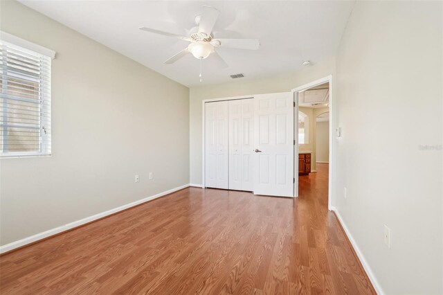 3691 Titanic Cir, Melbourne, FL 32903 - unfurnished bedroom featuring wood finished floors, a closet, baseboards, and a ceiling fan