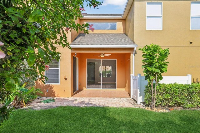 3691 Titanic Cir, Melbourne, FL 32903 - doorway to property featuring stucco siding, a ceiling fan, and roof with shingles