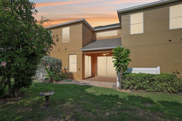 3691 Titanic Cir, Melbourne, FL 32903 - back of house featuring stucco siding and a lawn