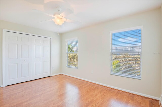 3691 Titanic Cir, Melbourne, FL 32903 - unfurnished bedroom with light wood-style flooring, baseboards, a closet, and ceiling fan