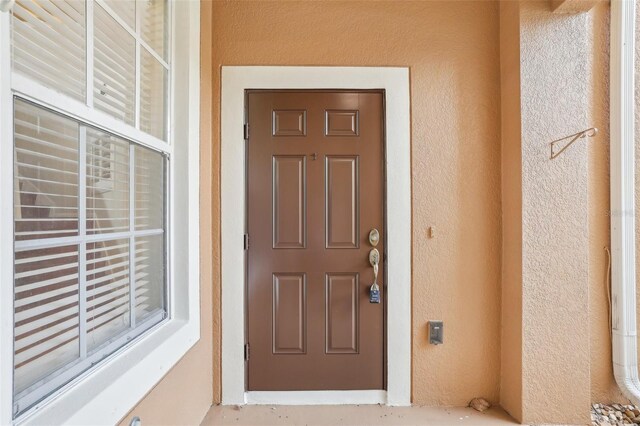 3691 Titanic Cir, Melbourne, FL 32903 - entrance to property with stucco siding