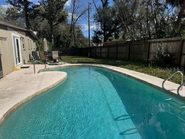 view of pool featuring a patio, a fenced backyard, and a fenced in pool