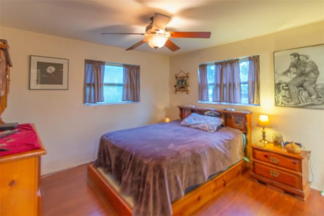 bedroom with ceiling fan and wood finished floors