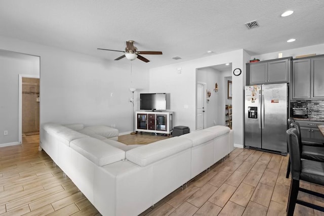 living area featuring baseboards, recessed lighting, visible vents, and wood tiled floor