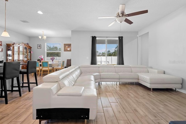 living room with a ceiling fan, wood finish floors, and recessed lighting