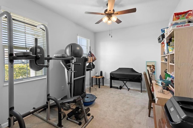 workout area featuring baseboards, plenty of natural light, a ceiling fan, and carpet flooring