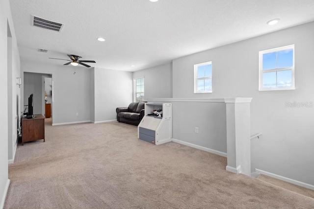 sitting room with visible vents, carpet floors, an upstairs landing, and baseboards