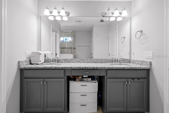 full bathroom featuring double vanity, visible vents, a sink, and a shower with shower door