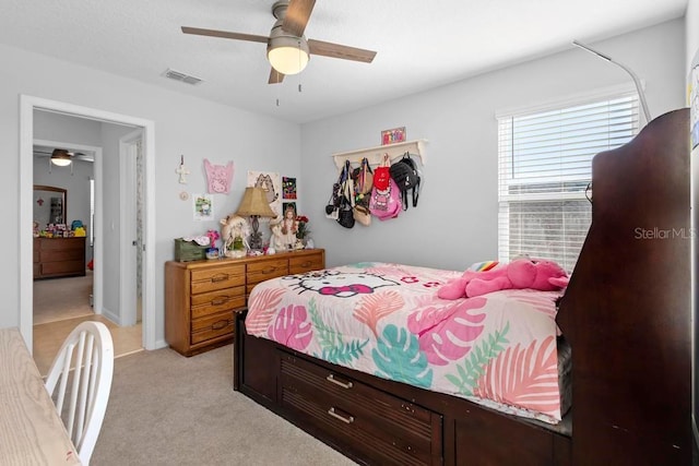 bedroom with a ceiling fan, light carpet, and visible vents