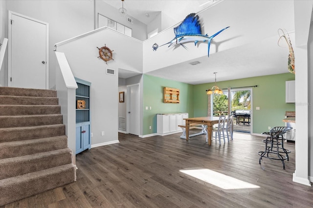 interior space featuring wood finished floors, baseboards, and stairs