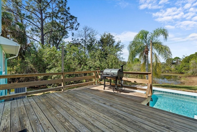 deck featuring a water view and area for grilling